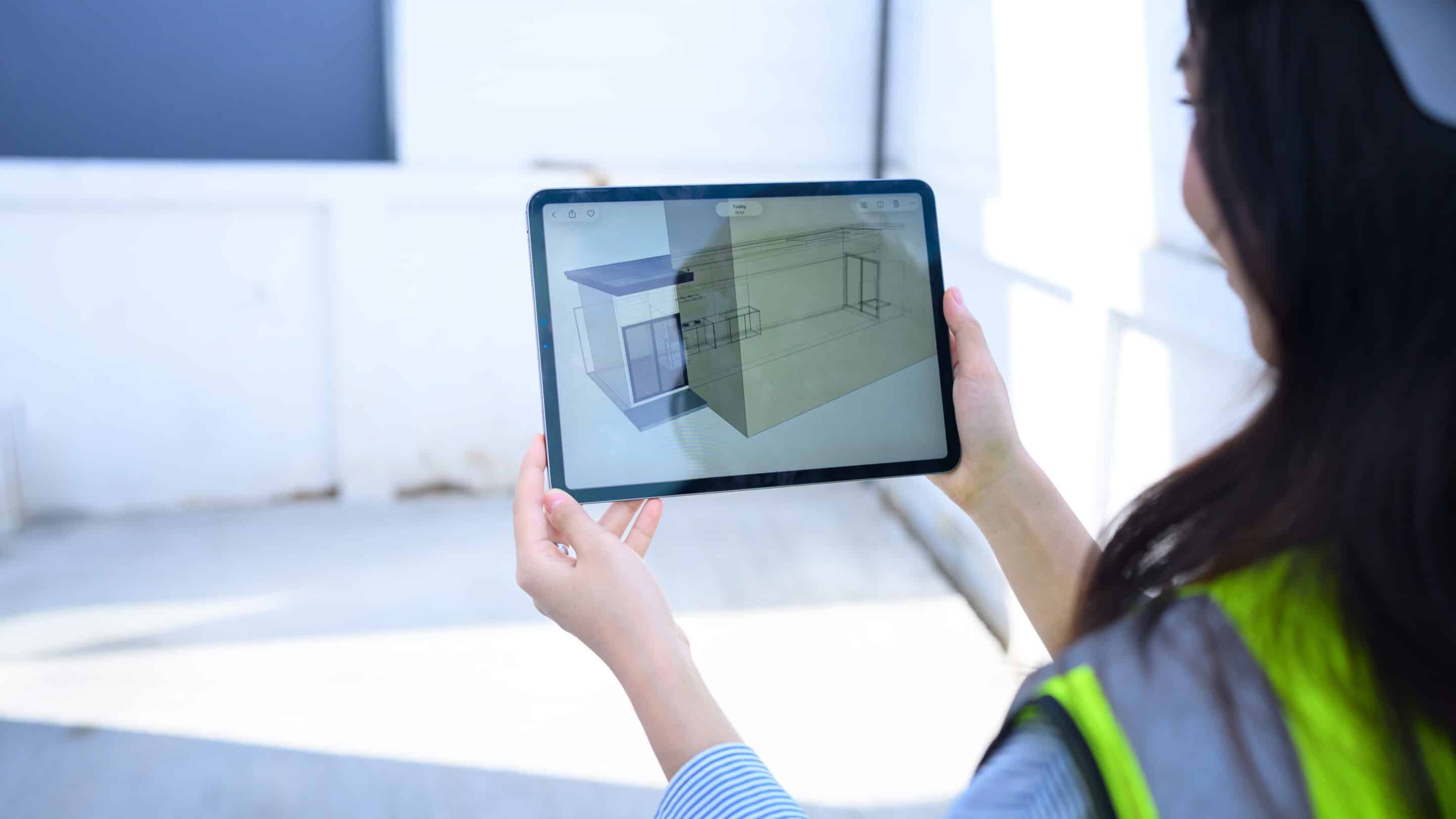 Female Engineer Using Tablet to View 3D Building Model at Construction Site